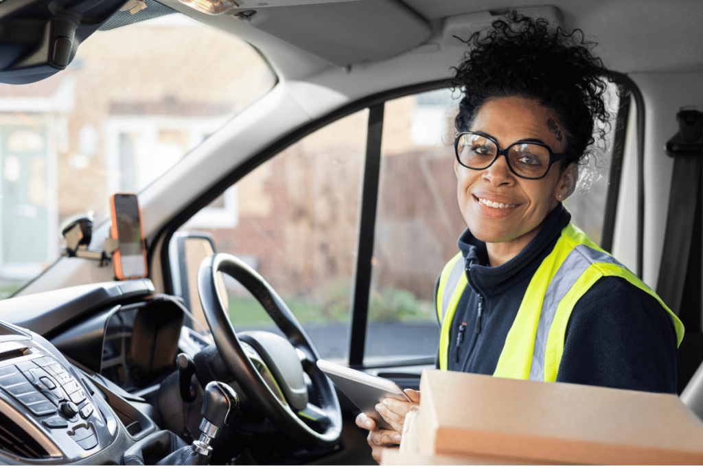 a female courier driver sat in the driving seat 