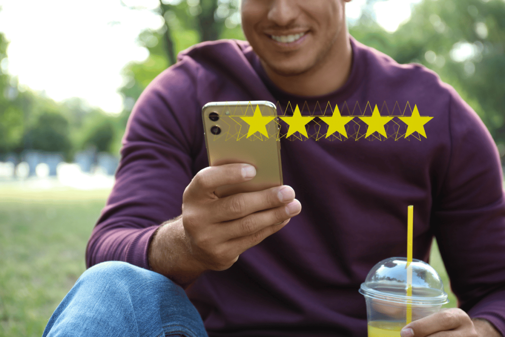 A man holding a phone and smiling with 5 stars superimposed in the foreground