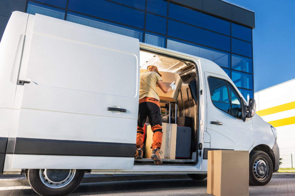 a courier unloading parcels from a white van