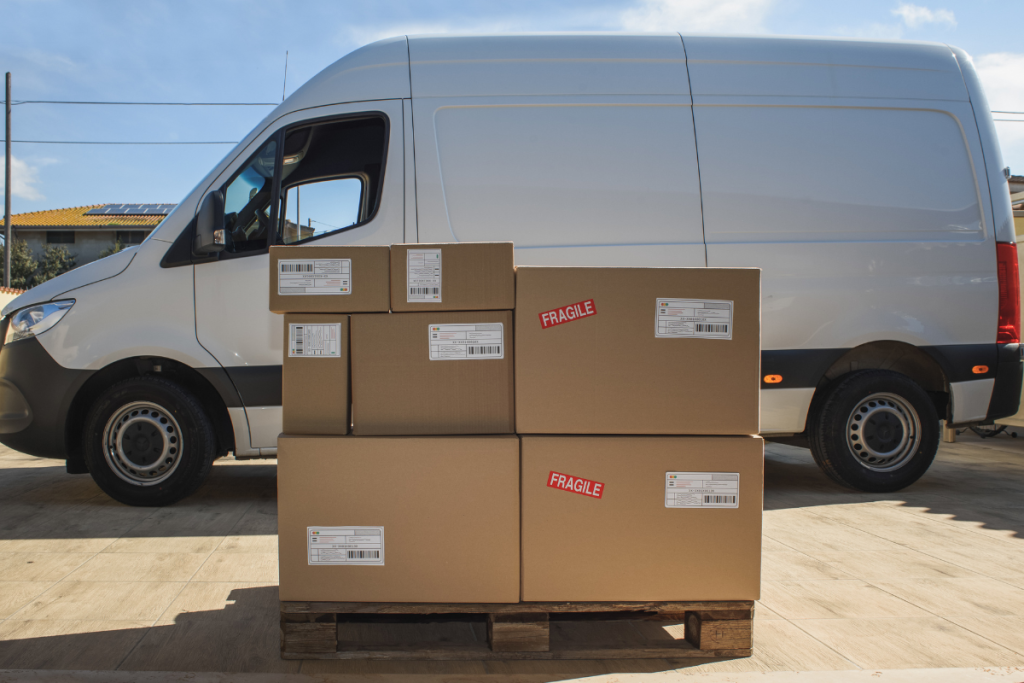 a white van with a pallet of boxes in front of it