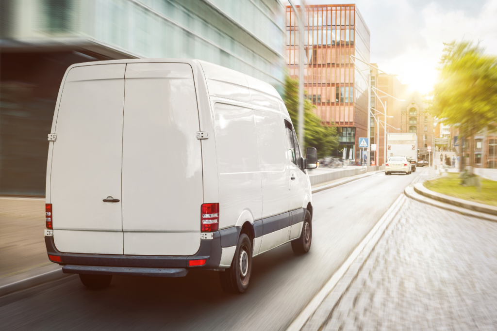 a white mercedes van in a city
