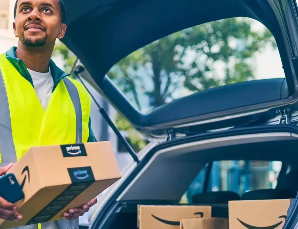 an amazon flex driver unloading a parcel from their vehicle