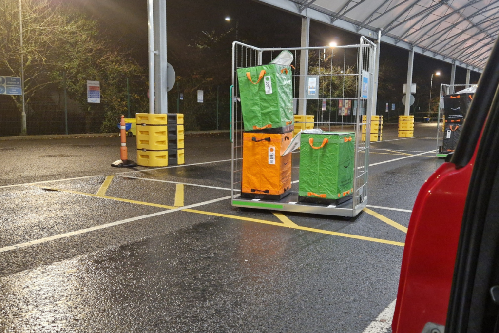 view from my car of cages ready to load at the amazon depot