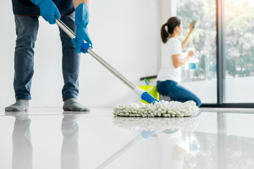 a man and woman cleaning a house