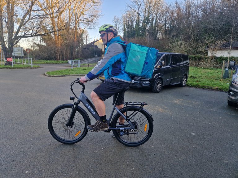 riding the HillMiles MileCity 1 e-bike for Stuart Delivery